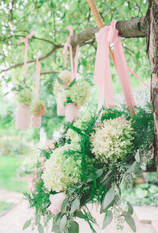Outdoor wedding decorations with pink ribbons and flowers