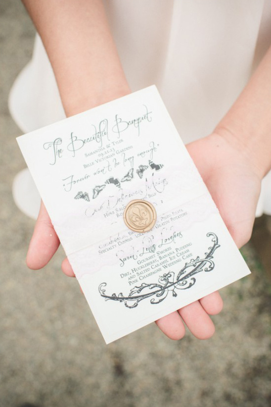 Elegant wedding invitation card held in gentle hands
