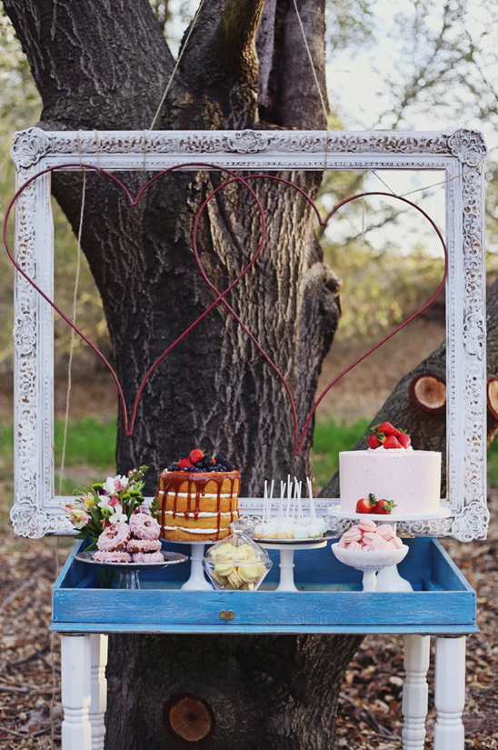 dessert table with framed hearts backdrop
