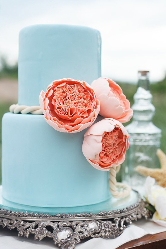 blue wedding cake with peach flowers