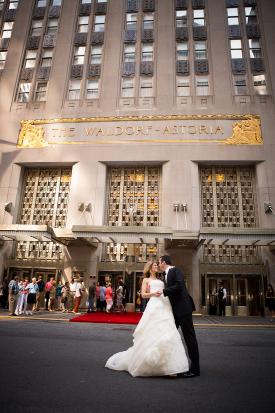 Wedding couple kissing in front of the Waldorf Astoria hotel