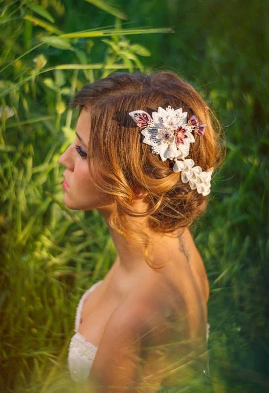 A bride with floral hair piece in nature, wedding photo