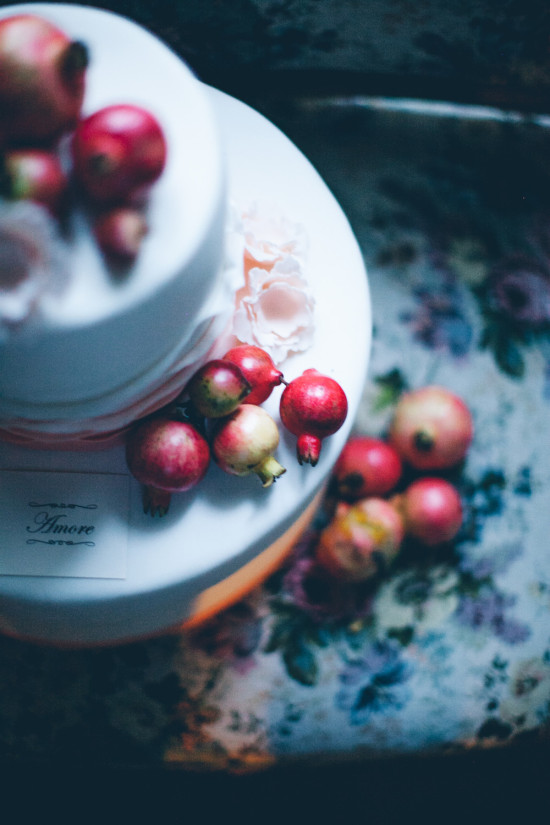 Elegant wedding cake with pomegranates and floral details