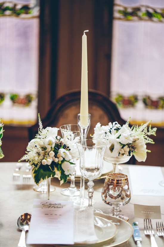 Elegant wedding table setting with candle and flowers