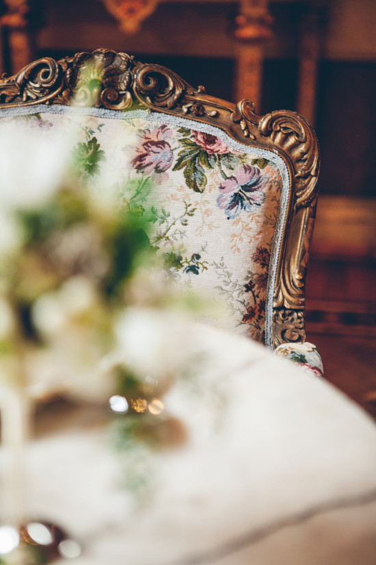 Floral patterned antique chair with ornate gold trim