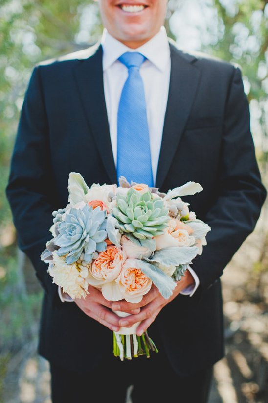 sharp looking groom in black and blue