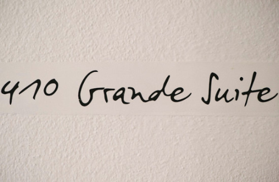 410 Grande Suite room number in black handwritten font