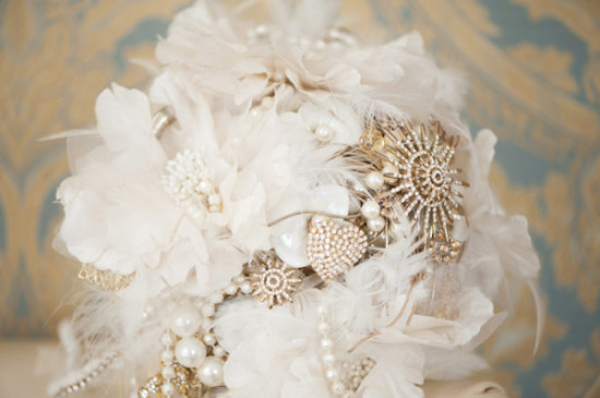 Elegant white and gold wedding bouquet with pearls and brooches