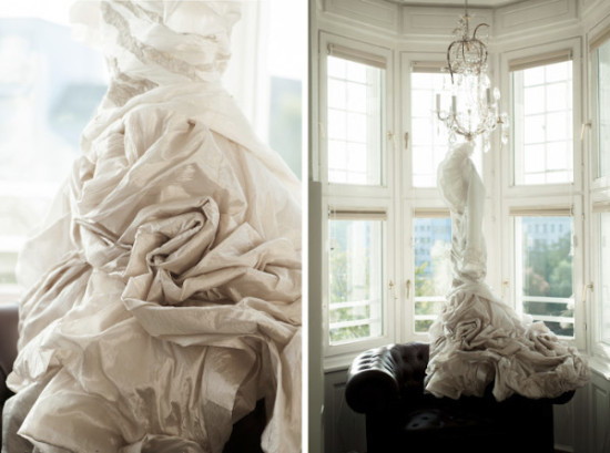 Elegant wedding gown with rosette detail near window