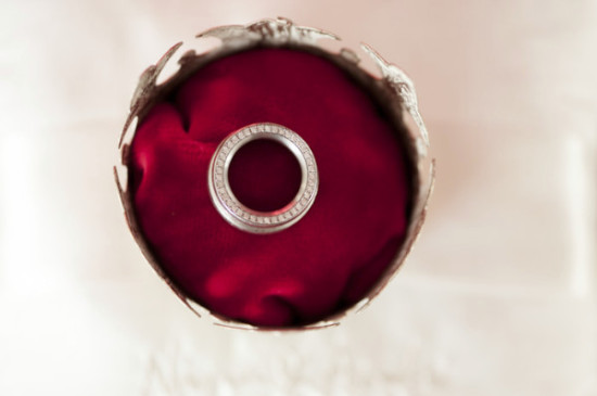 Diamond wedding ring in a red velvet pillow closeup
