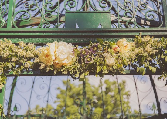Wedding arch decorated with vibrant flowers and greenery closeup view