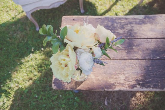 Beautiful peonies and lavender arrangement on rustic wooden table
