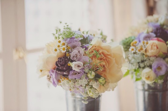 Beautiful pastel colored floral bouquets in metal containers