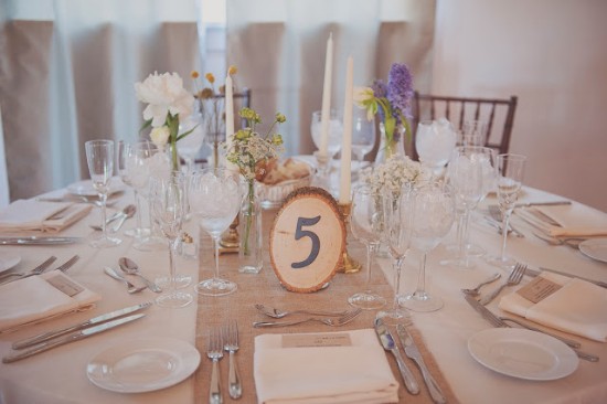Elegant wedding table setting with flowers and number five