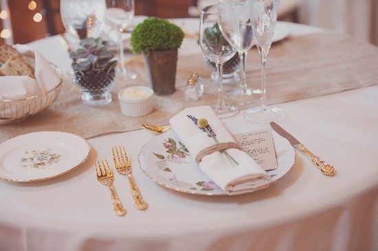 Elegant table setting with floral plates and golden cutlery