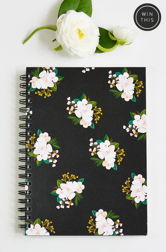 Black floral notebook with white flowers and Win this tag