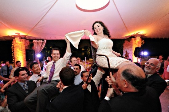Wedding couple is celebrated by friends in a joyful reception dance