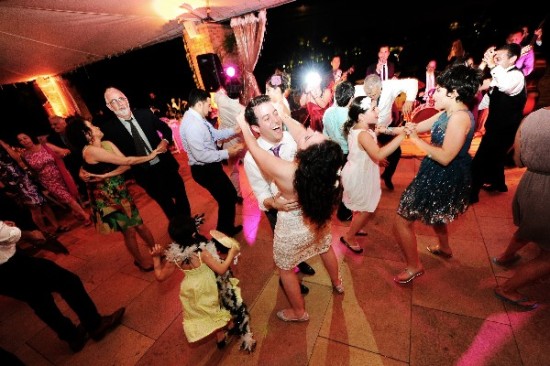 Happy people dancing at a wedding party, full of energy