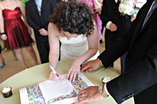 Bride signing the marriage certificate at wedding ceremony