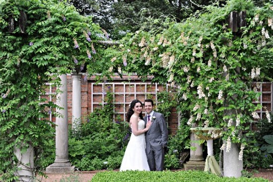 Happy couple posing on their wedding day, surrounded by nature