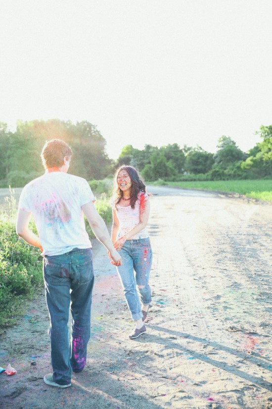 Couple in a joyful colorful run down a dirt road