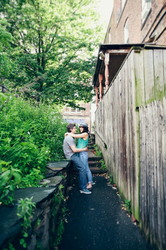 Couple embracing in a rustic urban alleyway setting