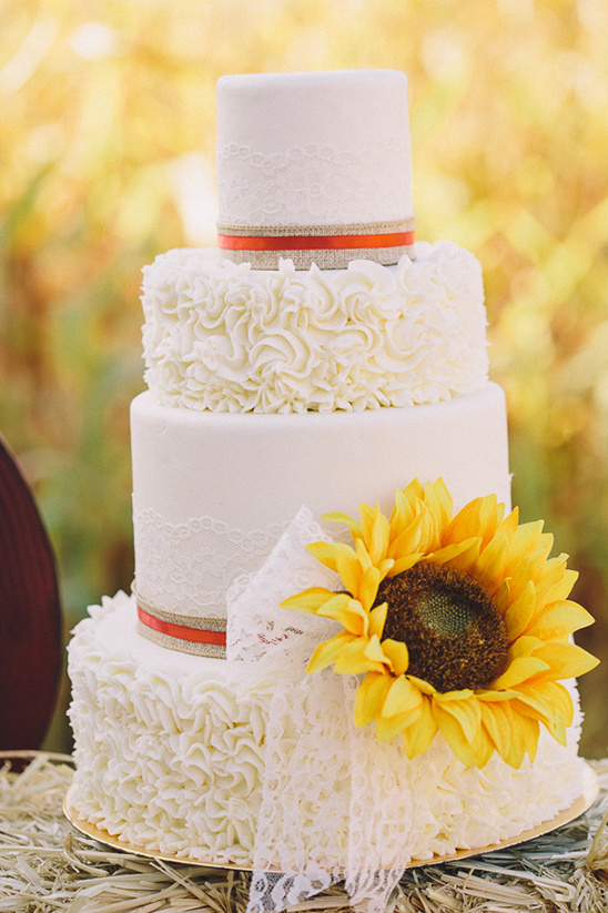 sunflower wedding cake on hay bale