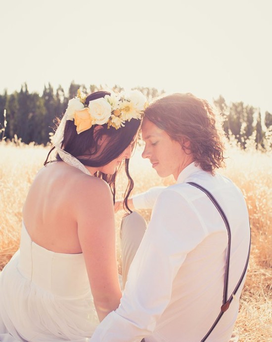 Romantic couple in love sitting in a field, flower crown
