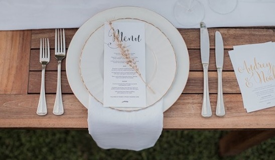 Elegant wedding place setting with menu and cutlery