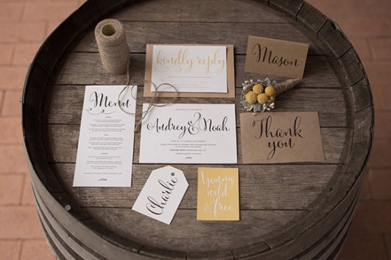 Rustic wedding stationary on wooden barrel table top