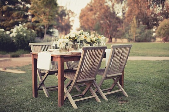 Outdoor garden party table setting with white flowers