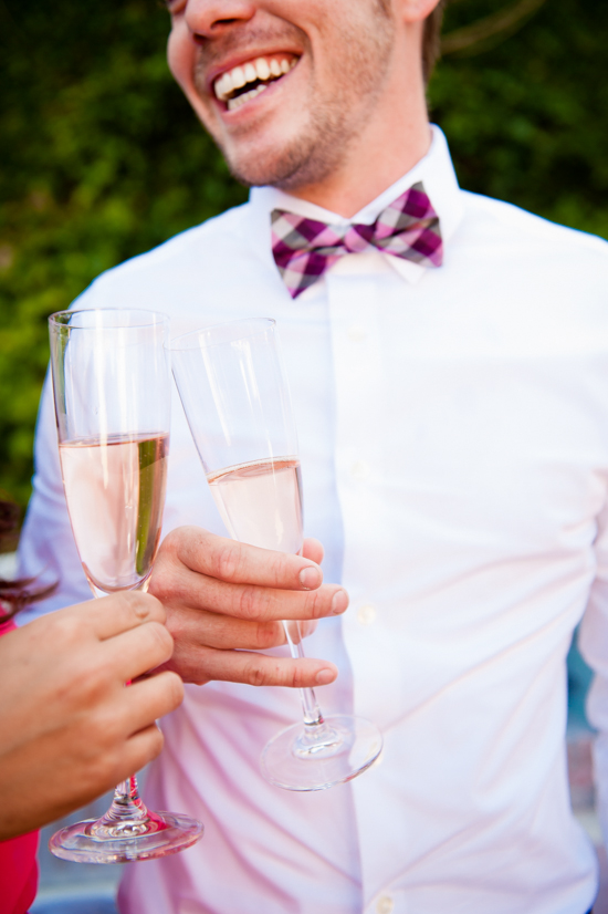 Man in bow tie toasting with champagne flutes