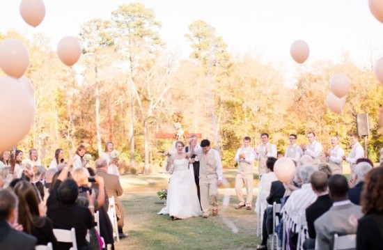 Newlyweds happily walking down the aisle at their wedding ceremony