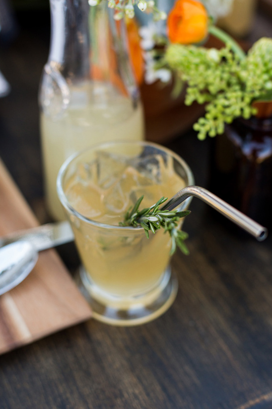 Refreshing cocktail with rosemary and metal straw