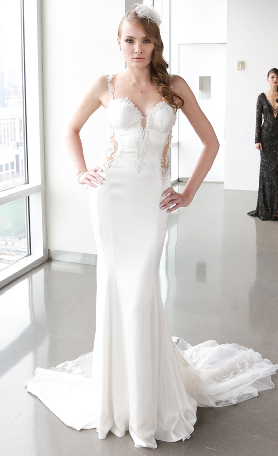 Stunning model in a white elegant wedding dress at a fashion show