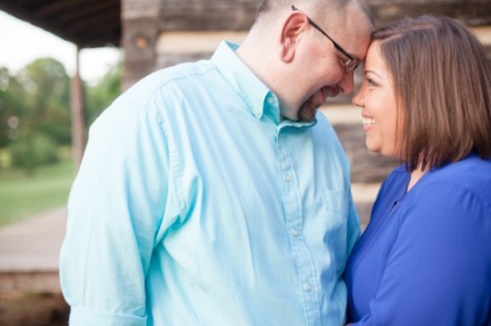 Couple touching foreheads and smiling at each other outdoors