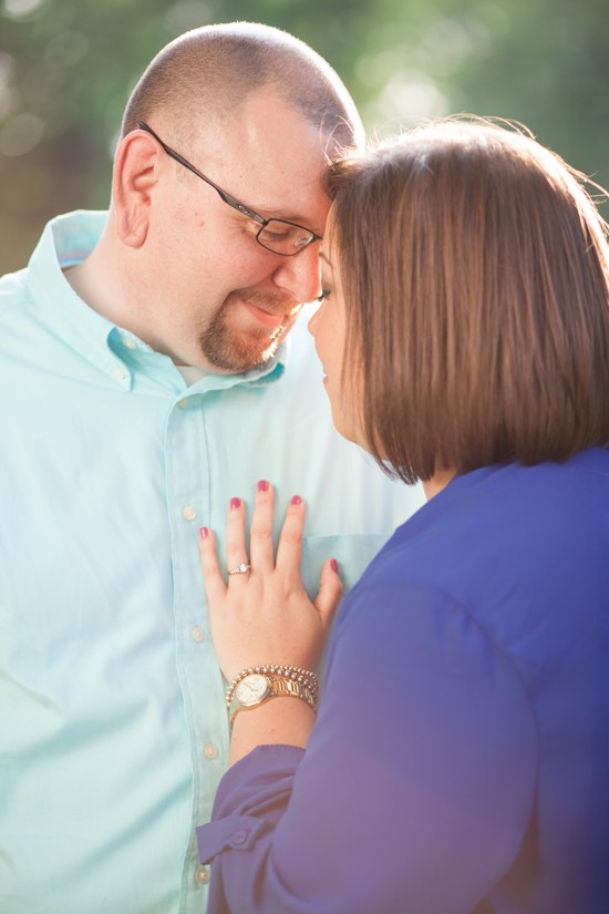 Loving couple gently touching foreheads outdoors