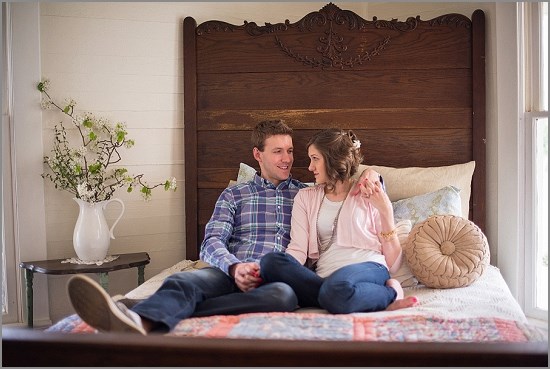 Couple cuddling on a bed in a cozy and romantic bedroom