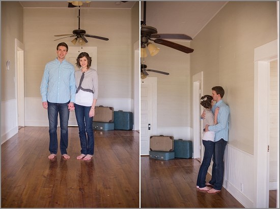 Couple embrace in a new home, with suitcases and bare feet