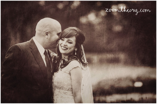 Bride and groom share a tender moment on their wedding day, sepia toned