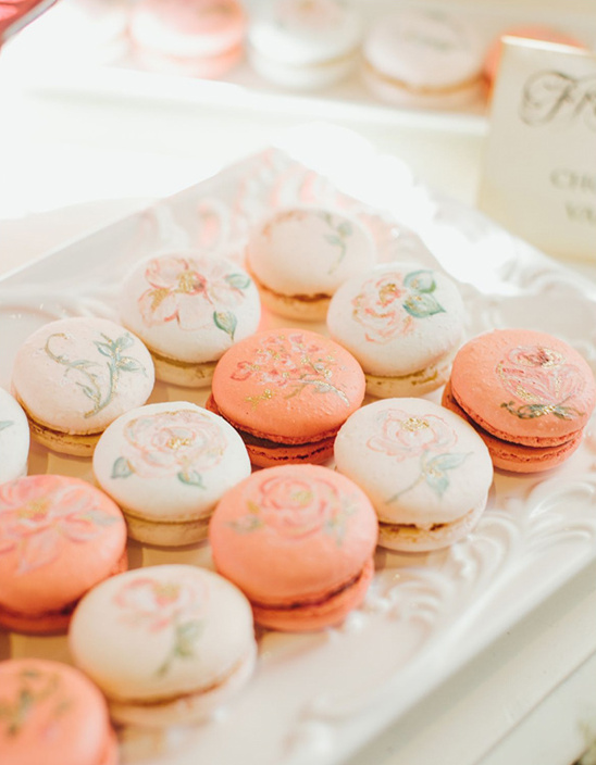 Elegant macarons with floral designs on display
