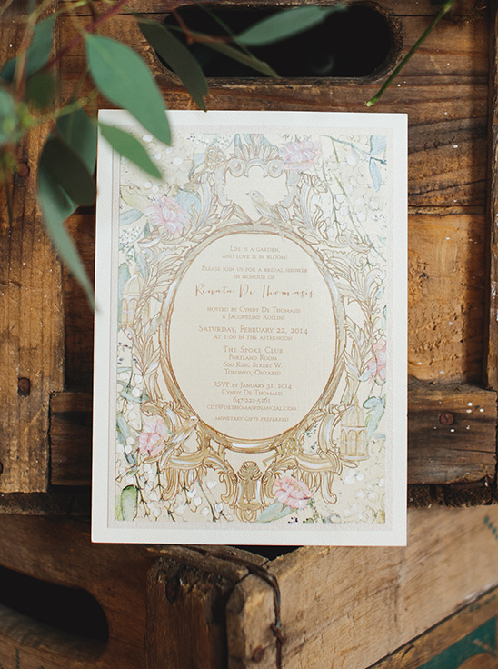 Floral watercolor wedding invitation on rustic wood