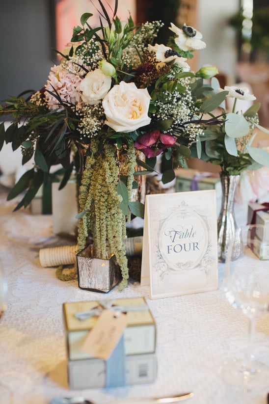 classic cascading centerpiece with book themed table number