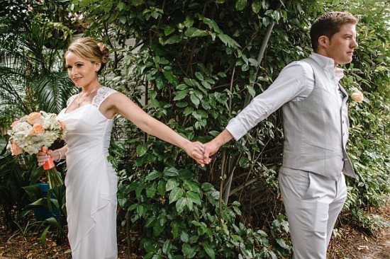 Bride and groom holding hands on their wedding day, nature background
