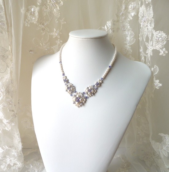 Elegant pearl and lavender crystal bridal necklace on a mannequin