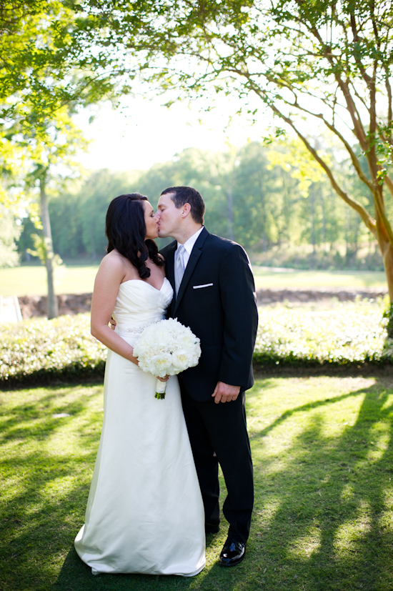 Happy couple kissing on their wedding day outdoors