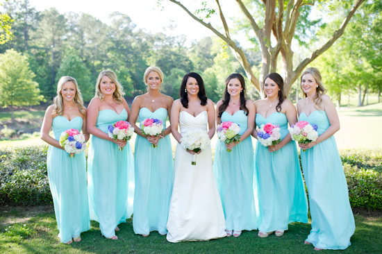 Bride with bridesmaids, all wearing blue dresses at a wedding