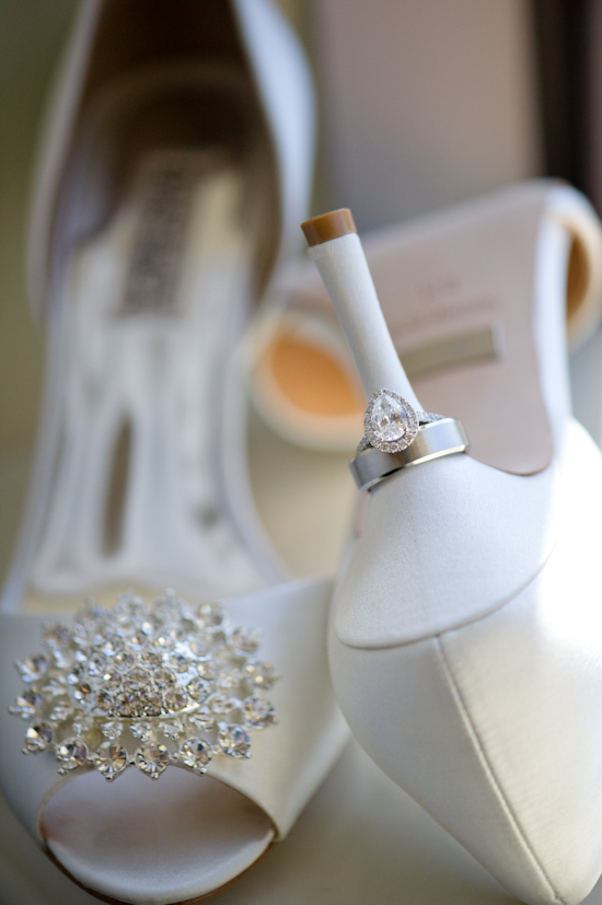 Elegant wedding rings on a white heel shoe, a symbol of marriage