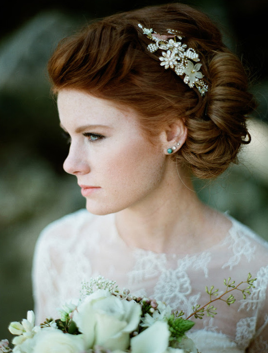 Redhead bride with flower hairpiece and white rose bouquet