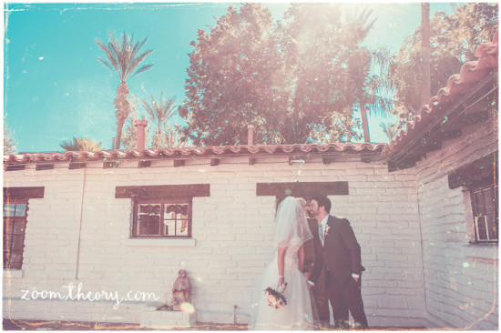 Romantic wedding kiss with vintage vibe in front of the building